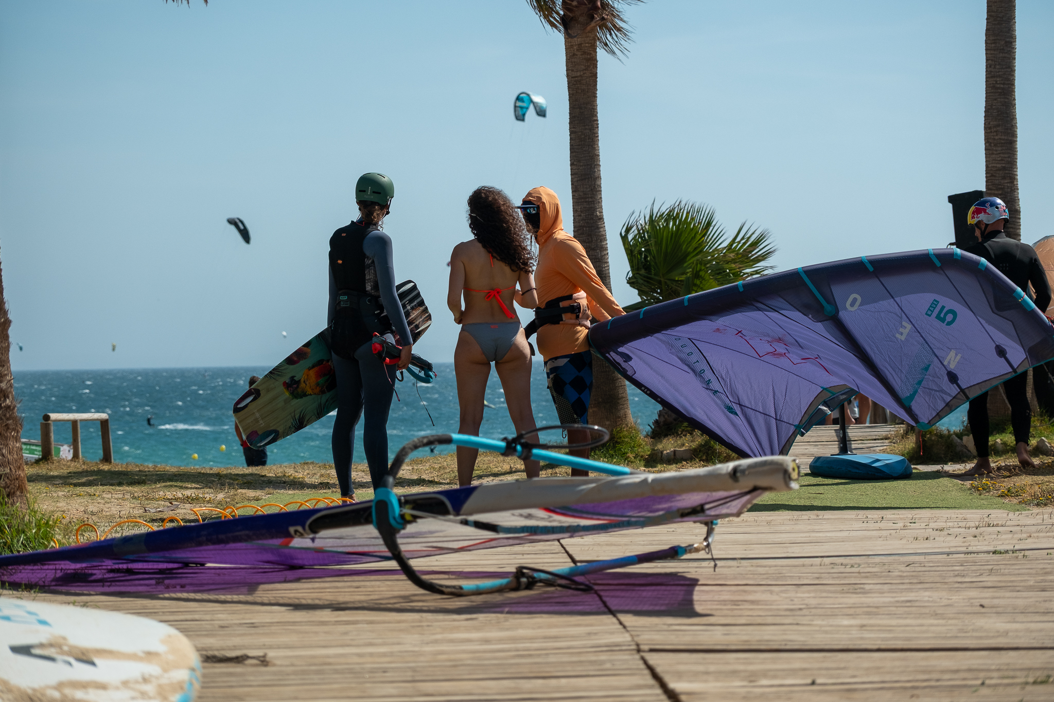 Kitesurfers preparing gear and checking wind conditions at Liam Whaley Pro Center in Tarifa, Spain