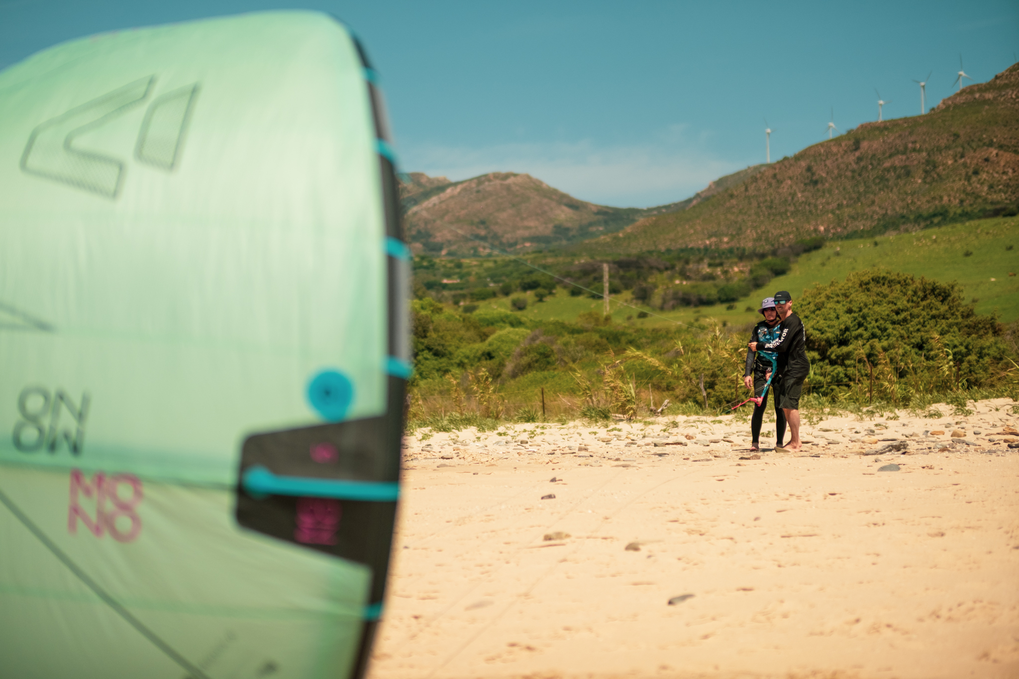 Kitesurfing instructor coaching a beginner on kite control at Valdevaqueros Beach in Tarifa