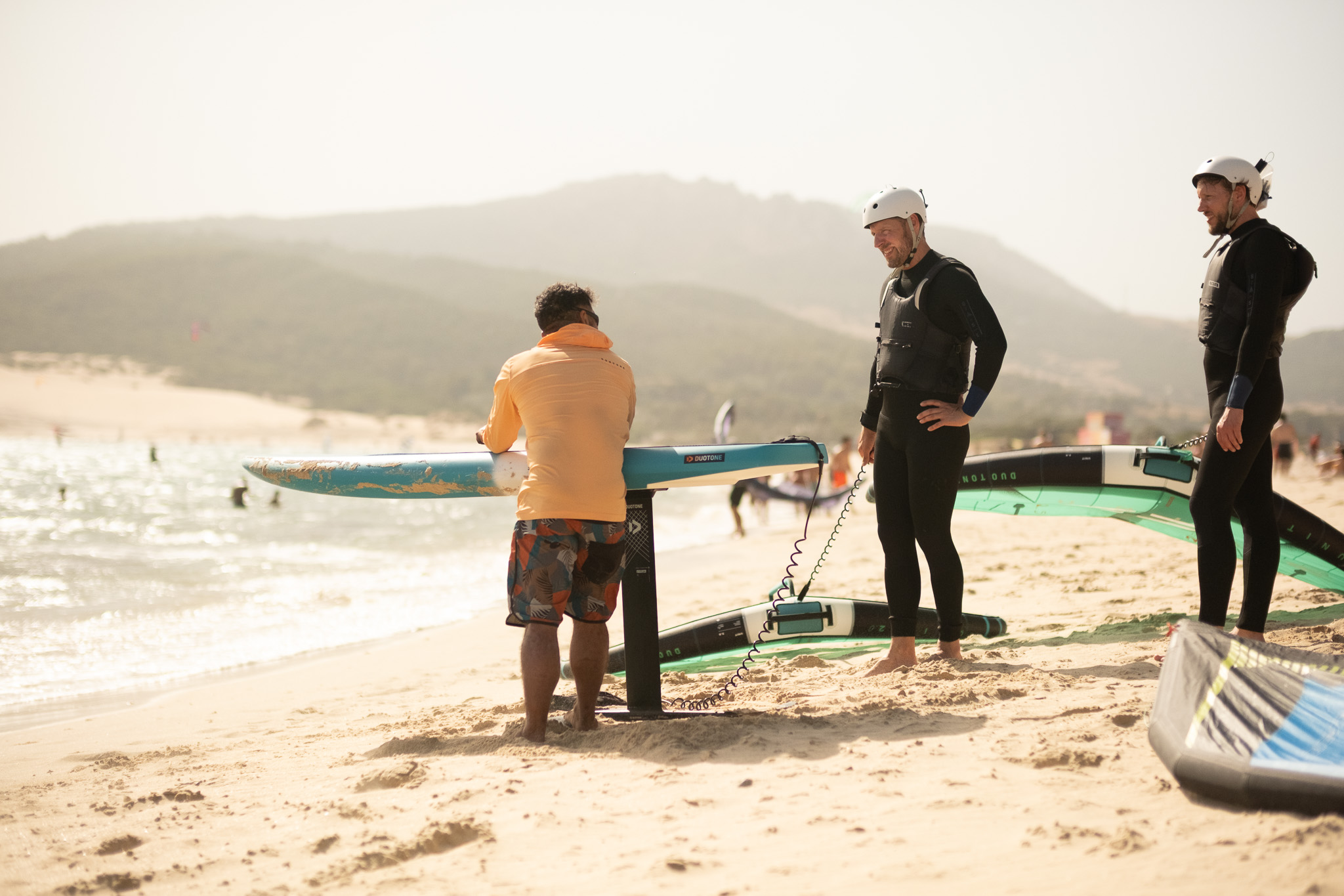 Wingfoil lesson at Valdevaqueros in Tarifa with instructor and students preparing foil equipment on the beach