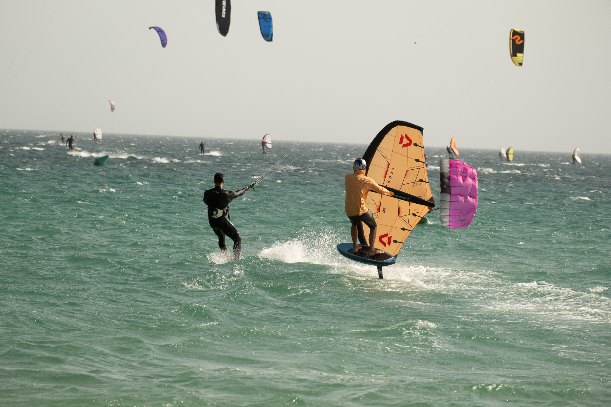 Kitesurfer and wingfoil rider sharing the water at Valdevaqueros Beach in Tarifa.