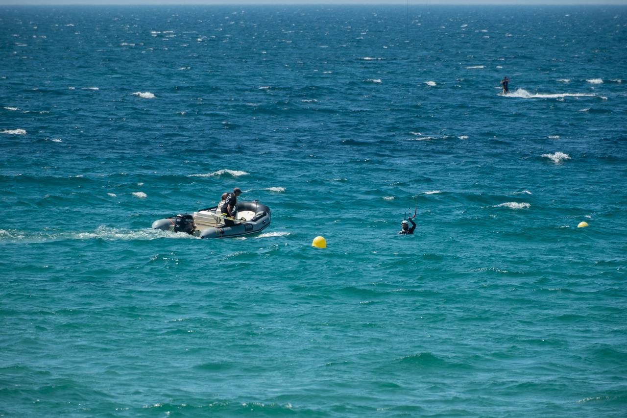 Kitesurf instructor assisting a student in the water during a beginner kitesurf lesson in Tarifa