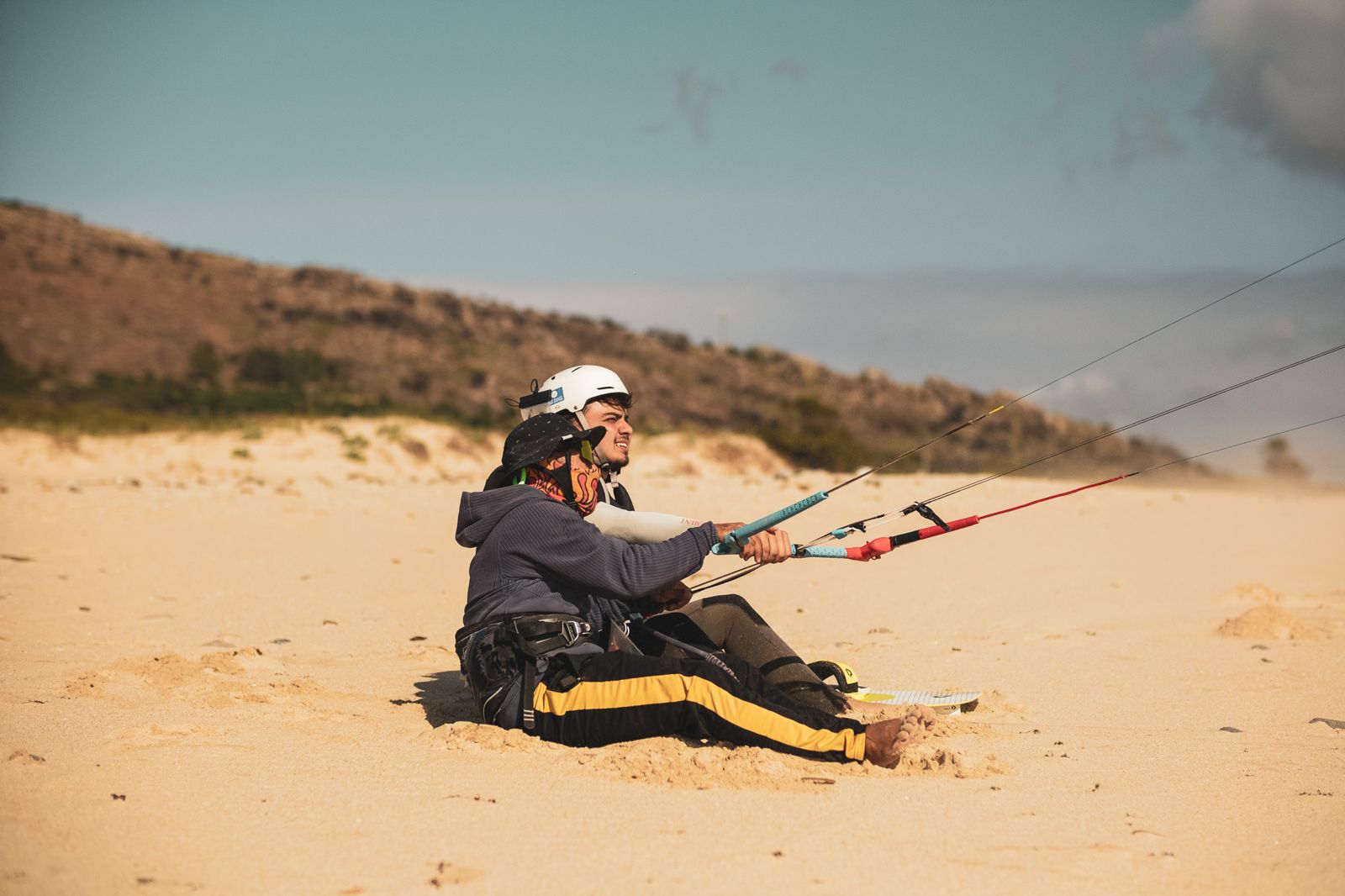 Beginner student learning kite control on the beach during a first kitesurfing lesson in Tarifa at Liam Whaley Pro Center.