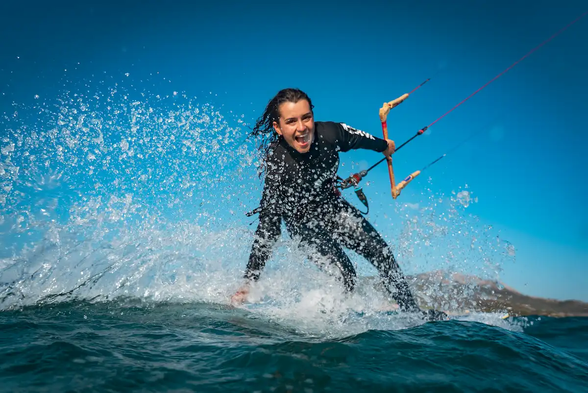 Beginner kitesurfer riding on the water in Tarifa with instructor-style control and strong spring wind conditions at Valdevaqueros