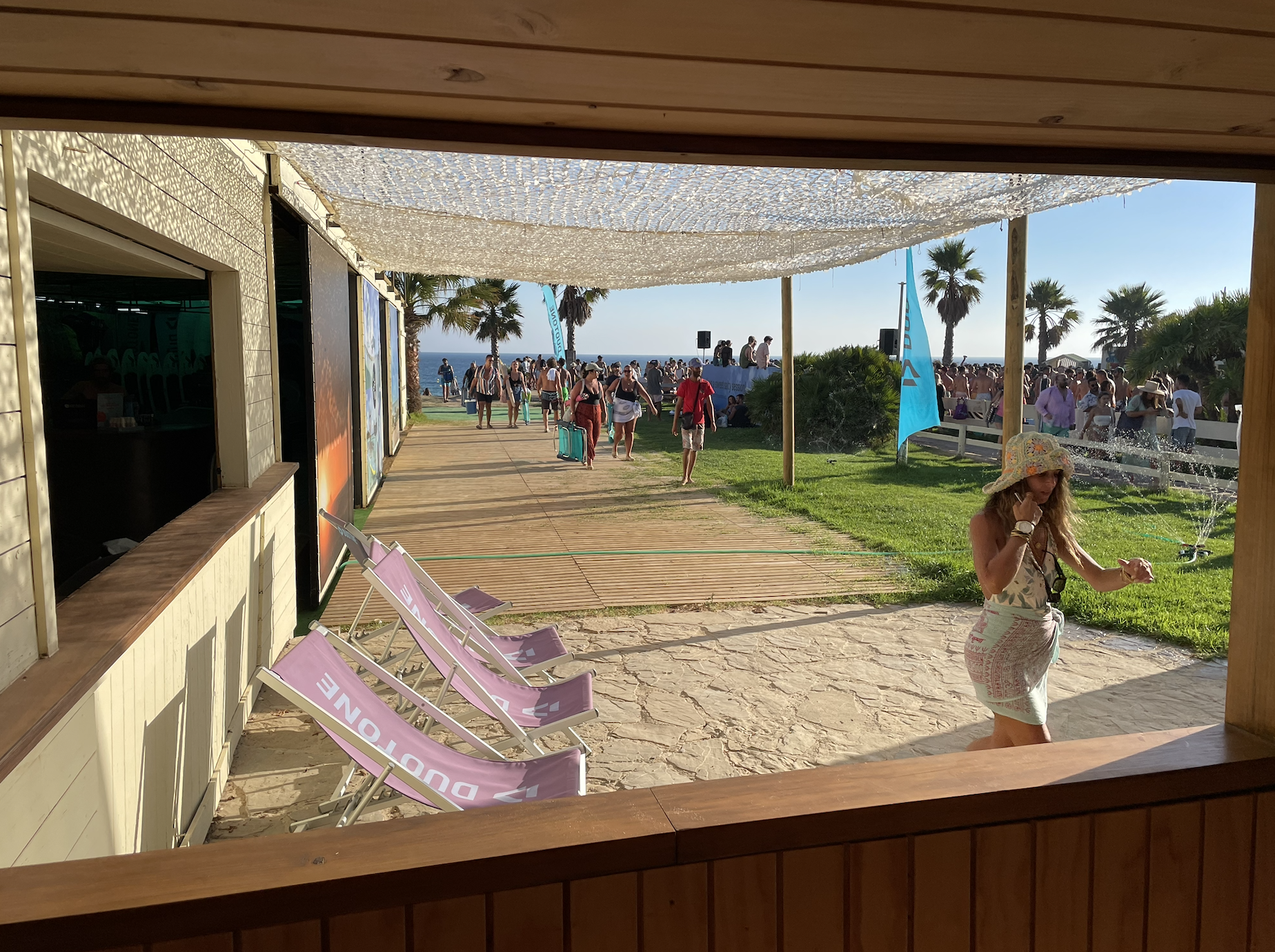 Beachfront scene at Valdevaqueros Tarifa with kitesurfers, Duotone setup area and social atmosphere during spring season