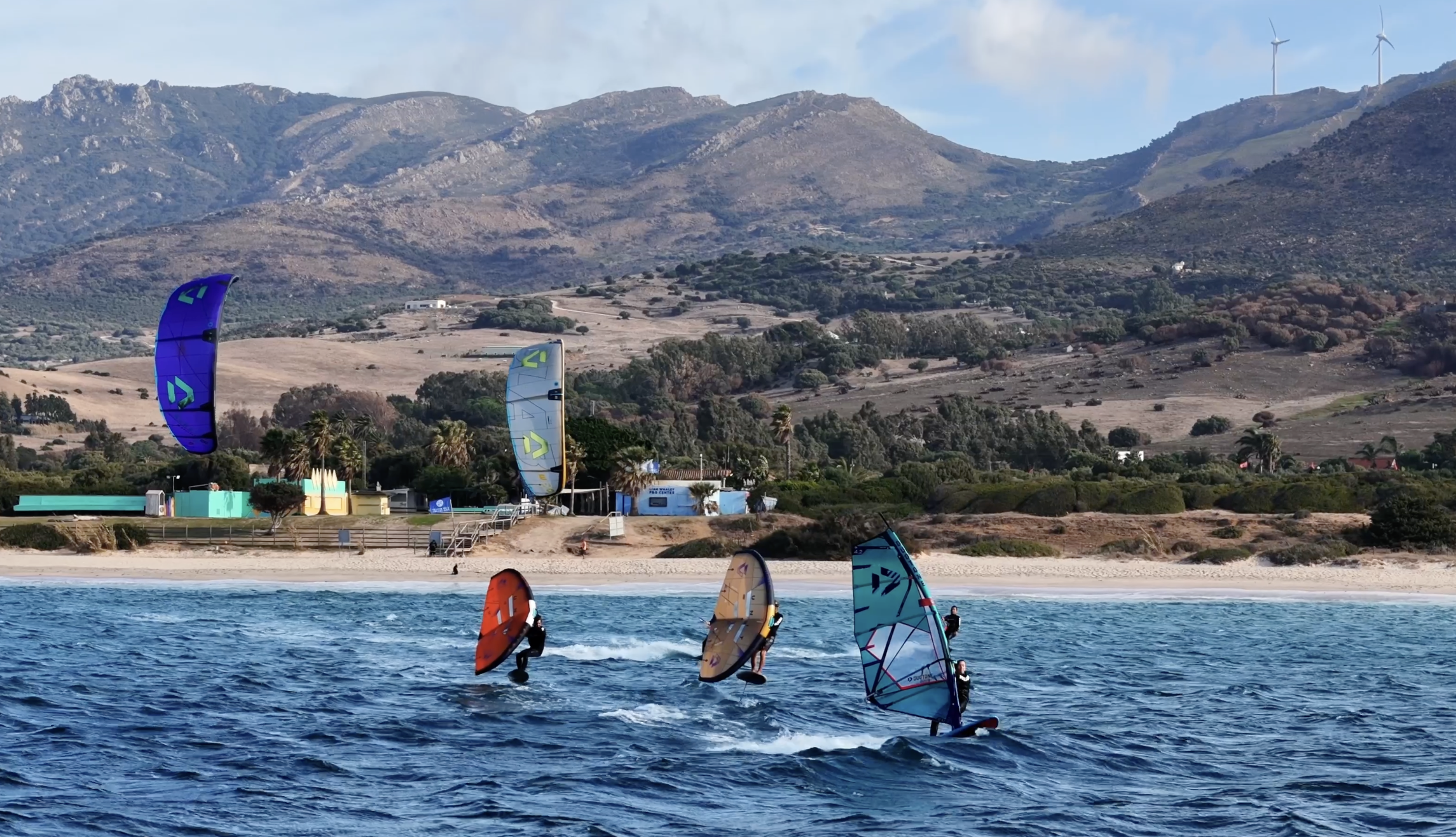 Wingfoilers riding in front of Liam Whaley Pro Center in Tarifa
