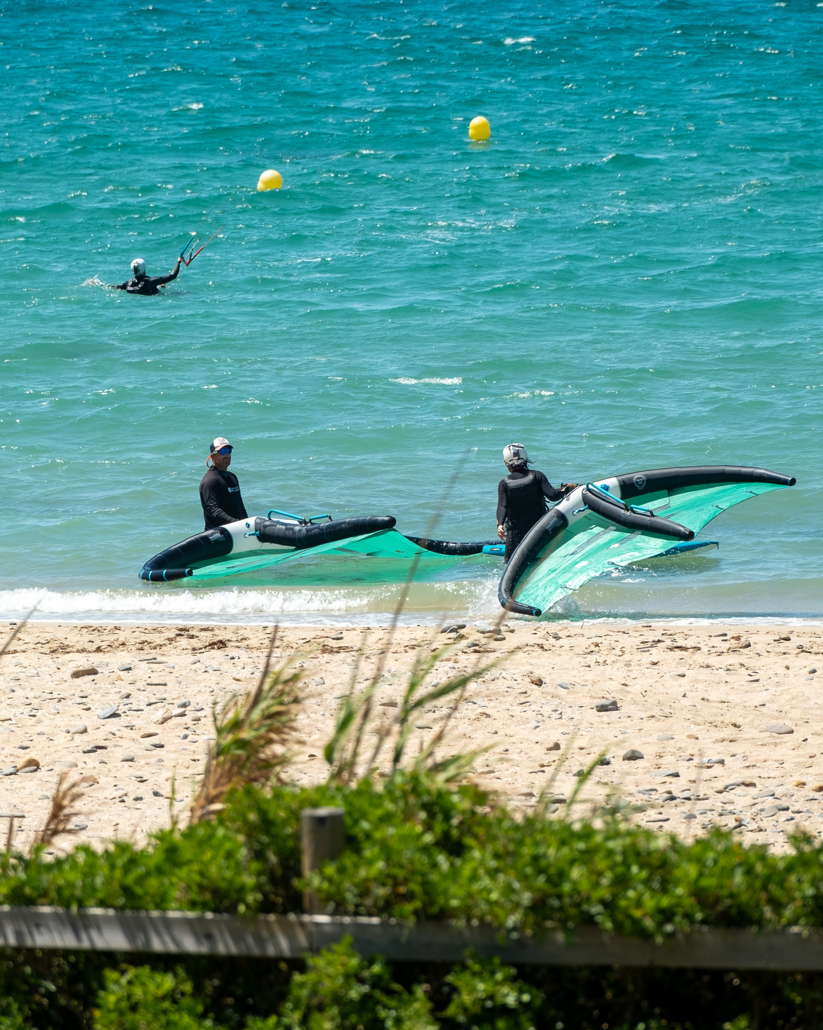 Wingfoil instructor and beginner student with wings at Valdevaqueros beach in Tarifa