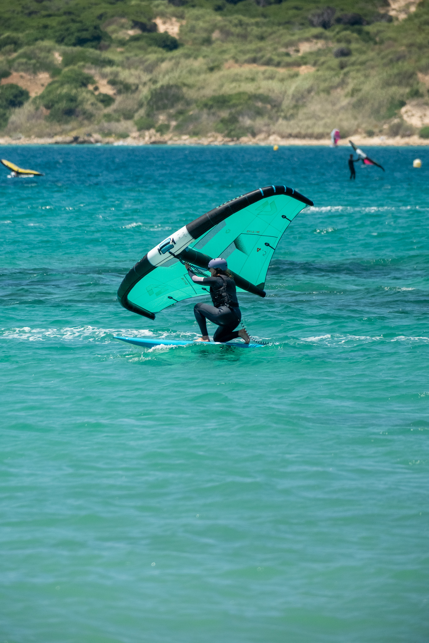 Child practising wing control and balance during a wingfoil lesson in Tarifa